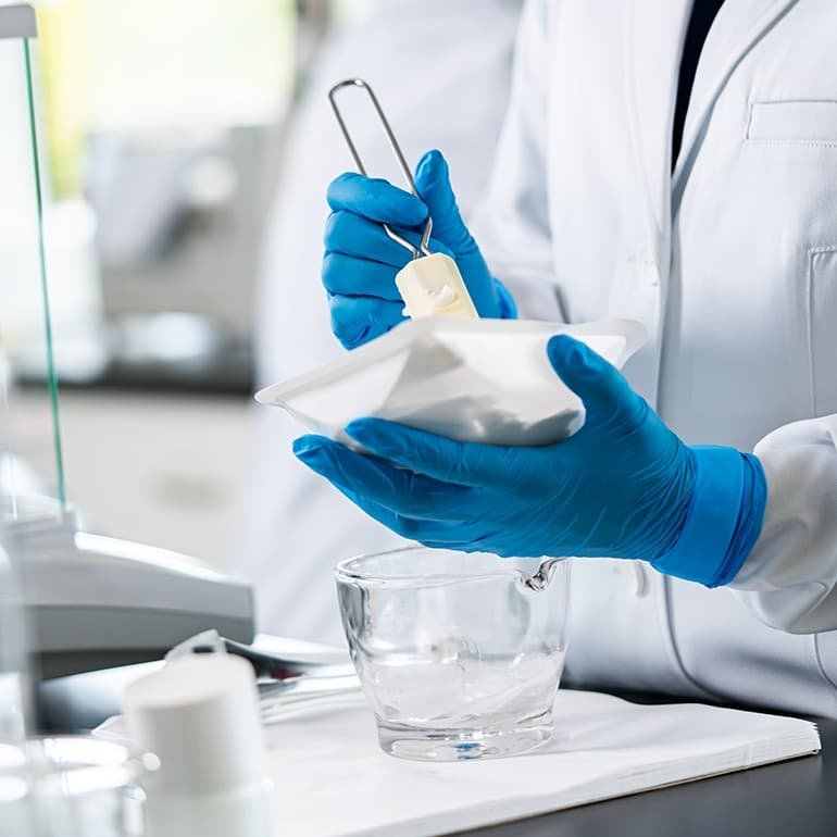 Pharmaceutical compounding laboratory preparing custom pain management cream