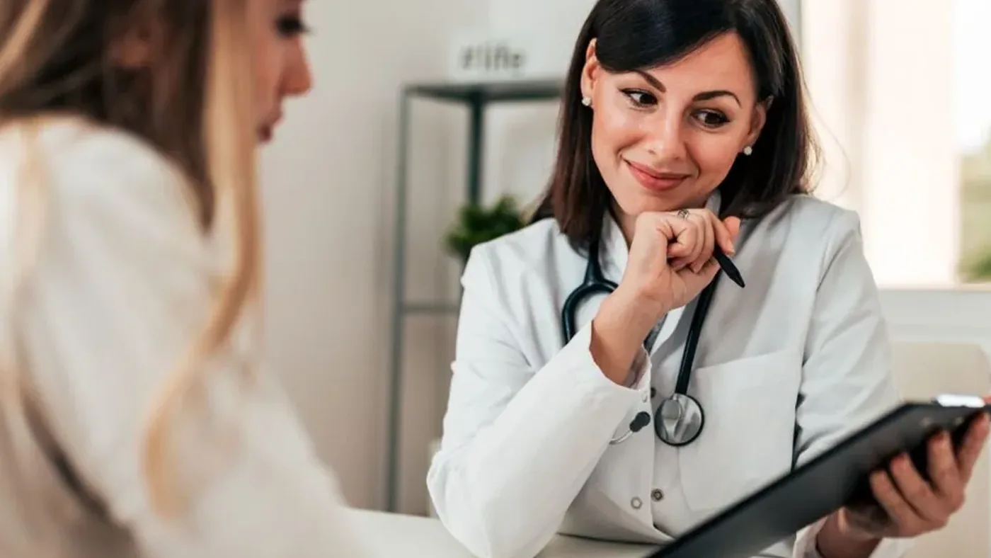 Healthcare professional discussing serious medication side effects with patient