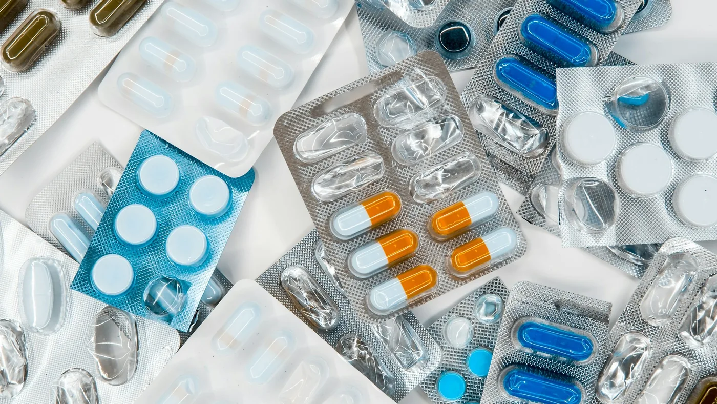 Pharmacy customer service representative assisting customers with prescription services
